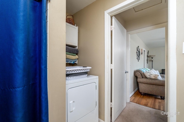 clothes washing area featuring washer / clothes dryer and light hardwood / wood-style flooring