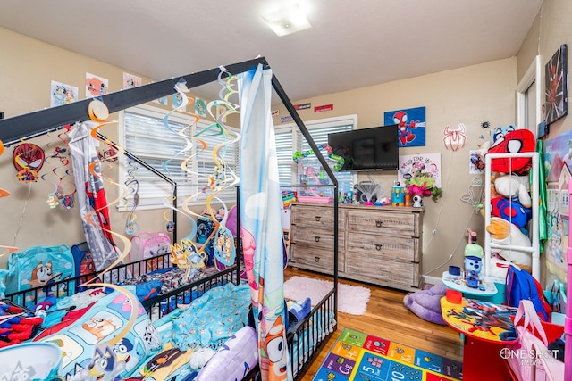 bedroom with hardwood / wood-style floors