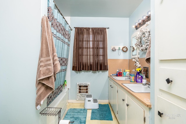 bathroom featuring heating unit, tile patterned flooring, and vanity