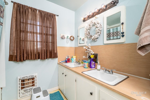 bathroom with vanity and heating unit