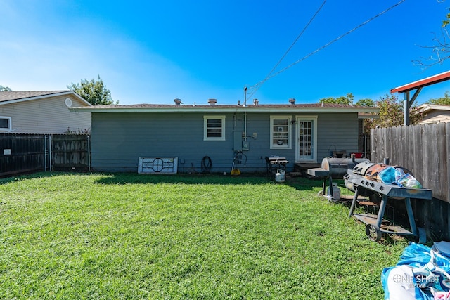 rear view of house with a lawn