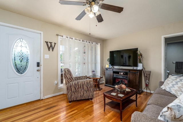 living room featuring light wood-type flooring and ceiling fan