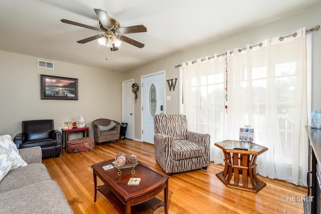 living room with hardwood / wood-style floors and ceiling fan