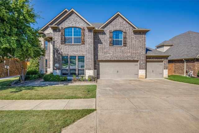 view of front facade featuring a garage and a front lawn