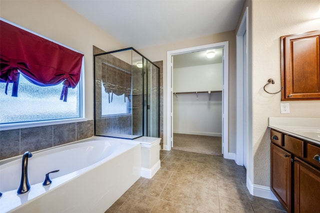 bathroom with plus walk in shower, tile patterned floors, and vanity