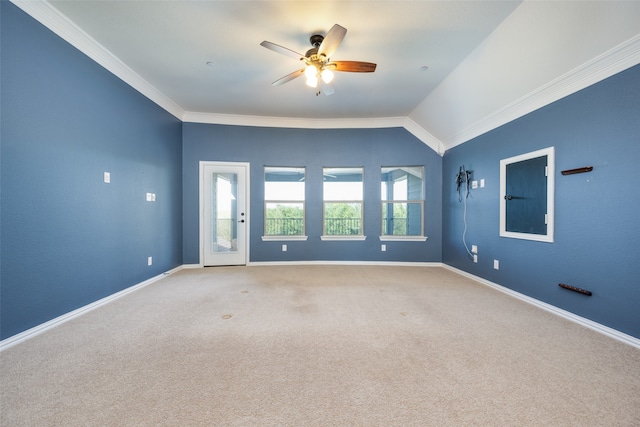 carpeted empty room featuring ceiling fan, lofted ceiling, and crown molding