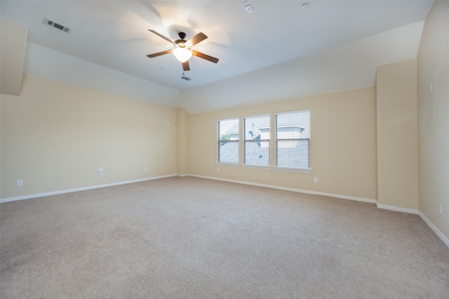 spare room featuring light carpet and ceiling fan