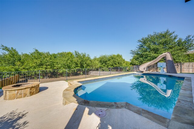 view of pool featuring a patio and a water slide