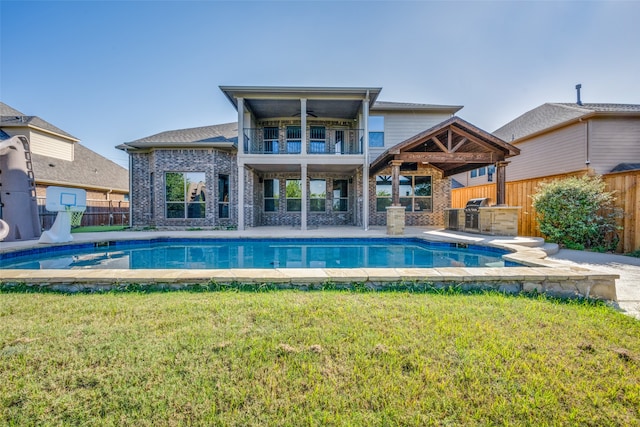 view of swimming pool with a lawn, a patio, and ceiling fan