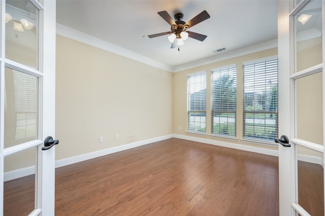 spare room with ornamental molding, ceiling fan, french doors, and dark hardwood / wood-style flooring