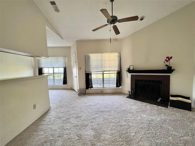 unfurnished living room featuring light carpet, a fireplace with flush hearth, visible vents, and lofted ceiling