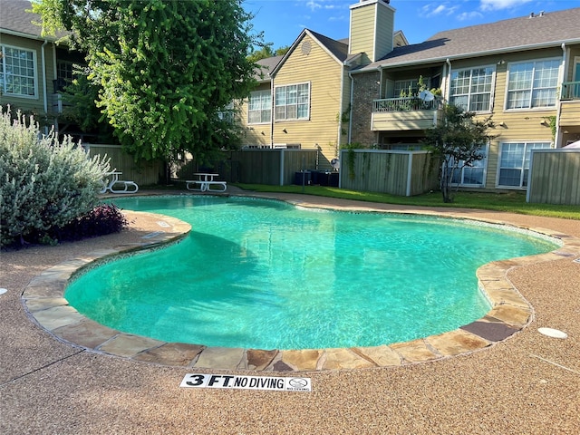 view of pool with fence and a fenced in pool