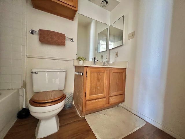 full bathroom with shower / tub combination, vanity, toilet, and hardwood / wood-style floors