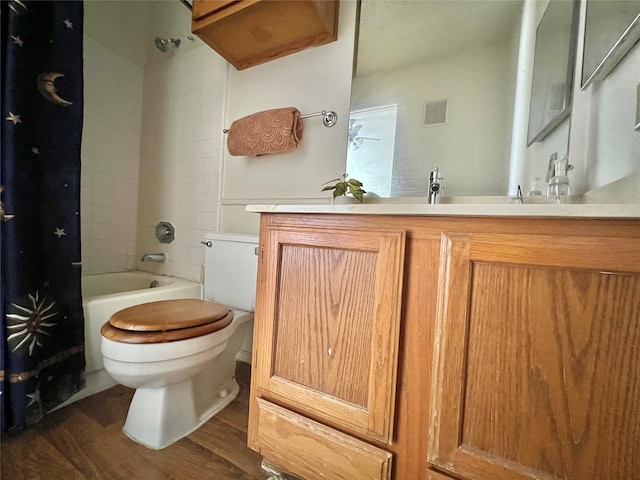 full bathroom featuring vanity, hardwood / wood-style flooring, shower / bath combination with curtain, and toilet