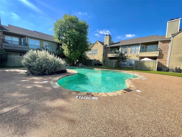 view of pool with a residential view and a fenced in pool