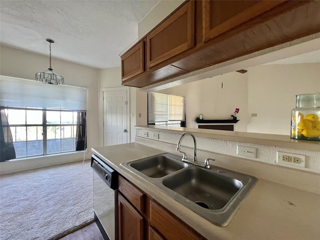 kitchen featuring dishwashing machine, light colored carpet, a sink, light countertops, and brown cabinets