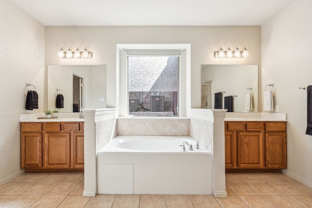 bathroom featuring a tub, tile patterned flooring, and vanity