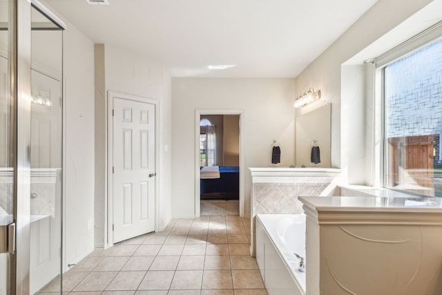 bathroom with tile patterned floors, plenty of natural light, and vanity