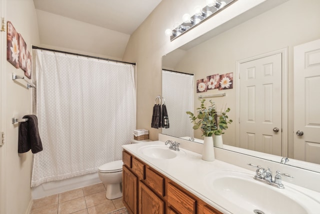 full bathroom featuring vanity, lofted ceiling, tile patterned flooring, toilet, and shower / bath combo with shower curtain