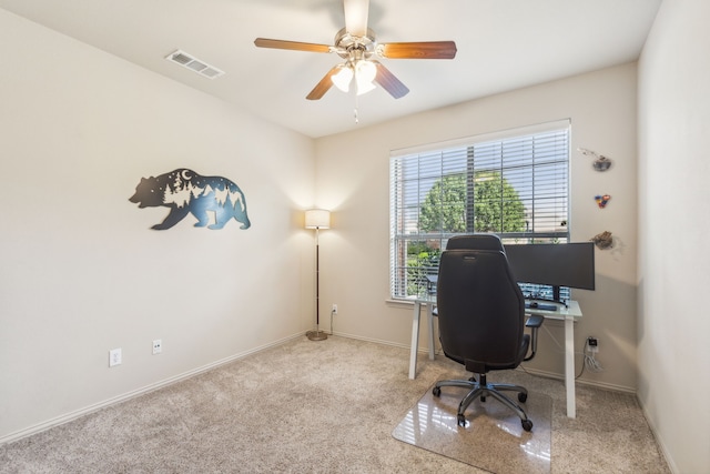 carpeted office with ceiling fan