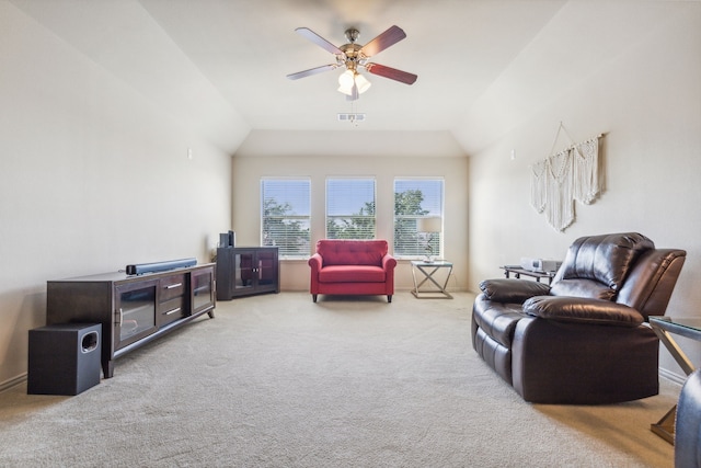 carpeted living room featuring ceiling fan and vaulted ceiling