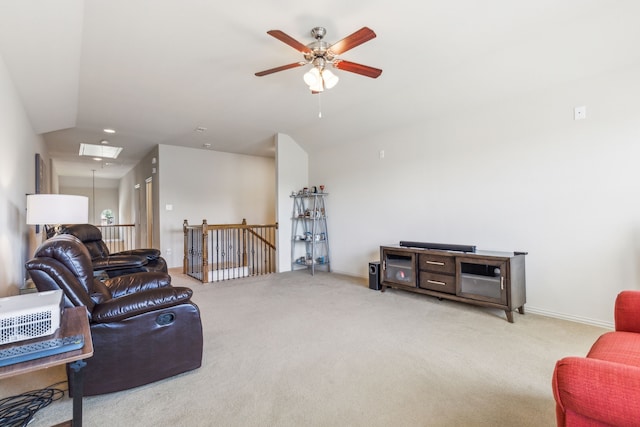 carpeted living room with ceiling fan and lofted ceiling