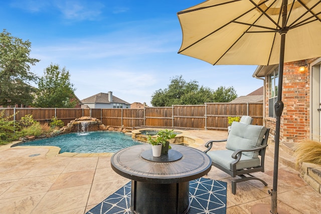 view of swimming pool featuring pool water feature, an in ground hot tub, and a patio