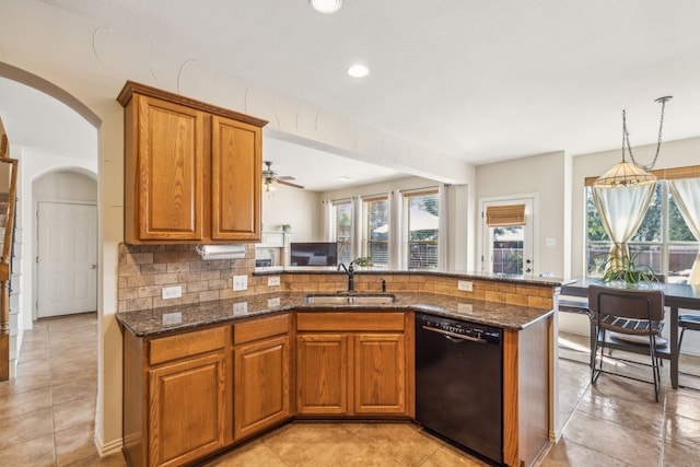 kitchen with a healthy amount of sunlight, sink, kitchen peninsula, and black dishwasher