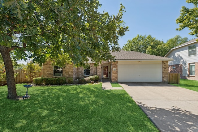 view of front of home with a front yard and a garage