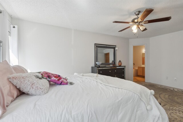 bedroom with ceiling fan, carpet, and a textured ceiling