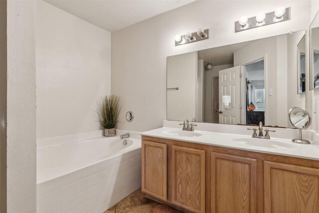 bedroom with a textured ceiling, ceiling fan, and ensuite bathroom