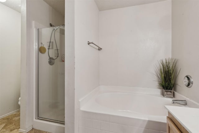 bathroom featuring a bathing tub, vanity, and a textured ceiling