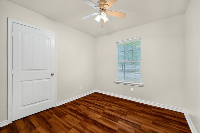 spare room featuring ceiling fan and dark wood-type flooring