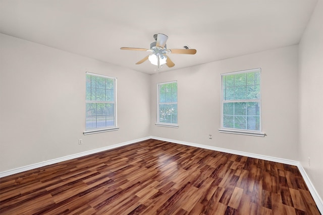 empty room with ceiling fan and hardwood / wood-style flooring