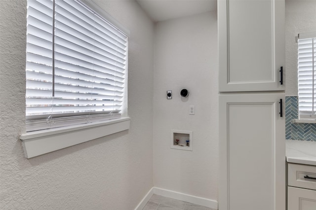 laundry area with baseboards, laundry area, hookup for a washing machine, and hookup for an electric dryer