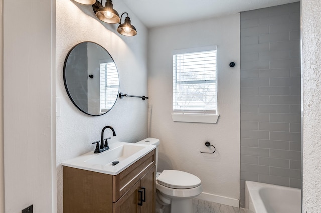 full bath featuring a textured wall, vanity, toilet, and baseboards