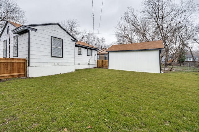 rear view of property with a yard and fence