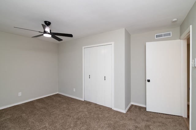 unfurnished bedroom featuring ceiling fan, carpet floors, and a closet