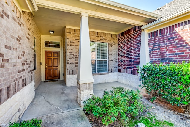 view of exterior entry featuring a porch