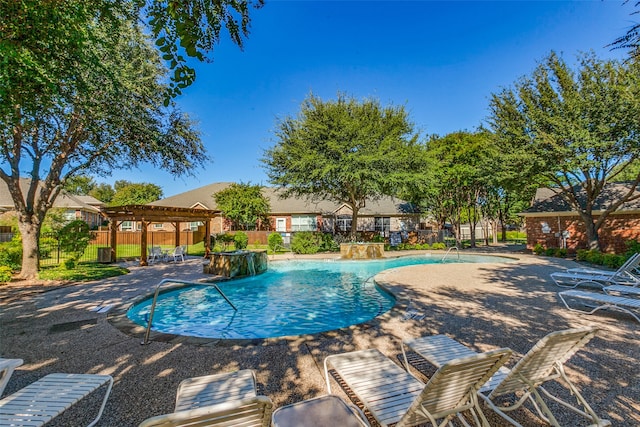 view of swimming pool with a pergola, pool water feature, and a patio area