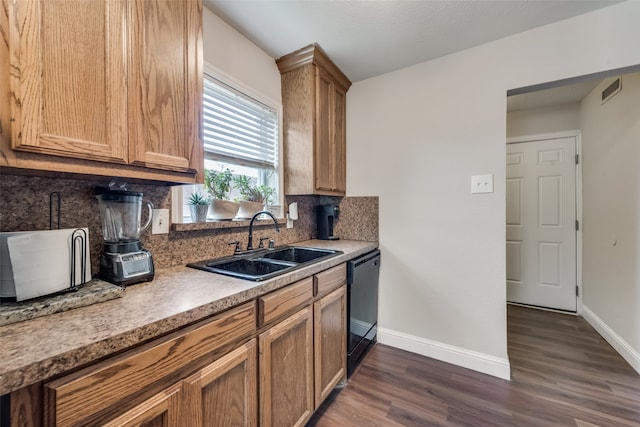 kitchen featuring black dishwasher, dark hardwood / wood-style floors, sink, and tasteful backsplash