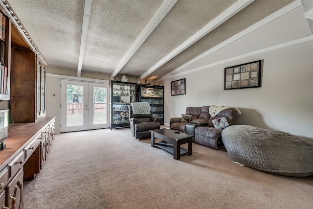 living room with vaulted ceiling with beams, a textured ceiling, light colored carpet, and french doors