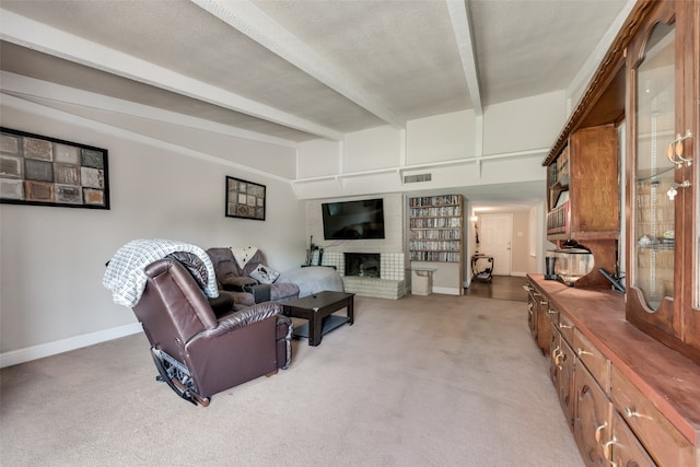 carpeted living room featuring a textured ceiling, a fireplace, and beamed ceiling