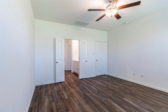 unfurnished bedroom featuring ceiling fan and dark hardwood / wood-style flooring