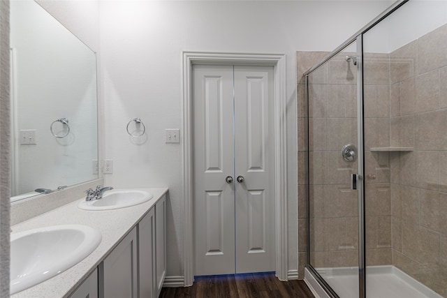 bathroom featuring vanity, a shower with shower door, and hardwood / wood-style floors