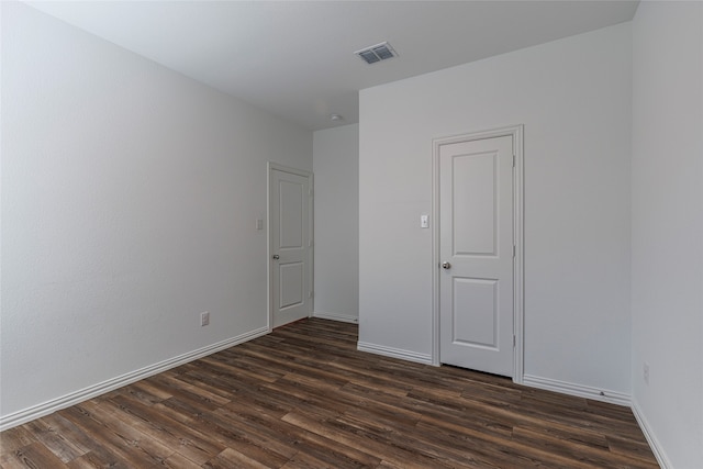 spare room with dark hardwood / wood-style flooring