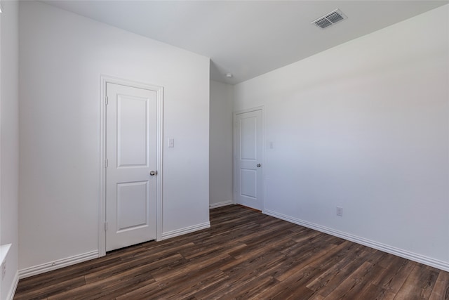 spare room with dark hardwood / wood-style flooring