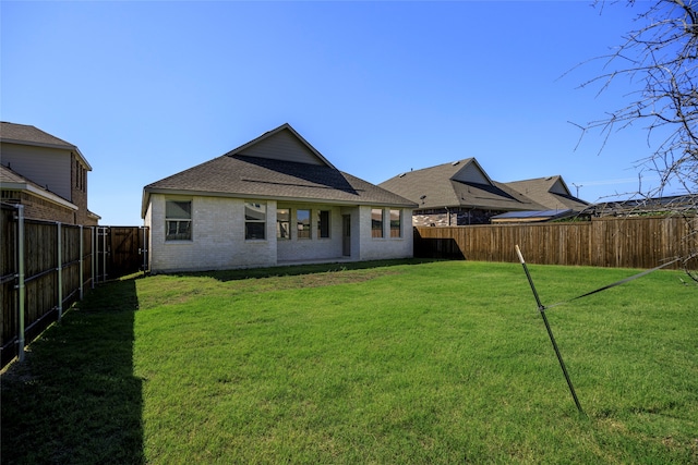 rear view of house with a lawn