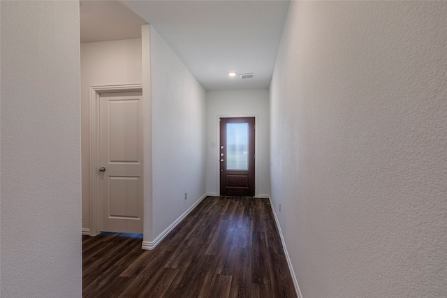 doorway with dark wood-type flooring