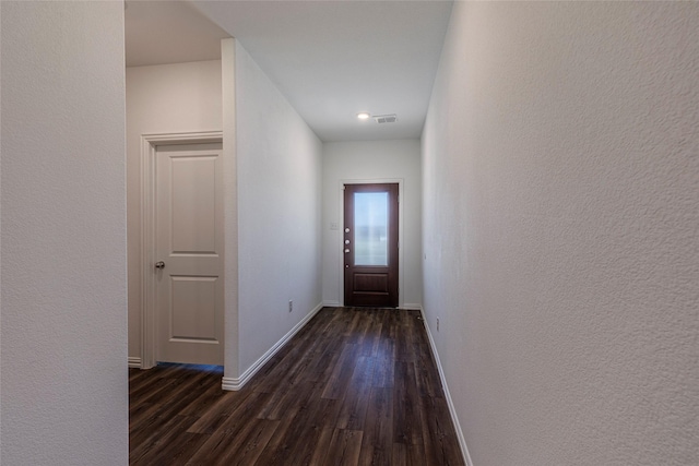 6049 Pensby Dr, Celina, TX 76227 - doorway featuring dark wood-type flooring, visible vents, a textured wall, and baseboards